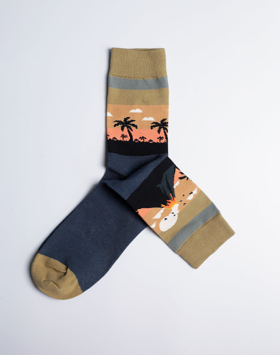 A pair of gold-yellow and navy blue Hawaiian crew socks featuring a vibrant volcano eruption design.