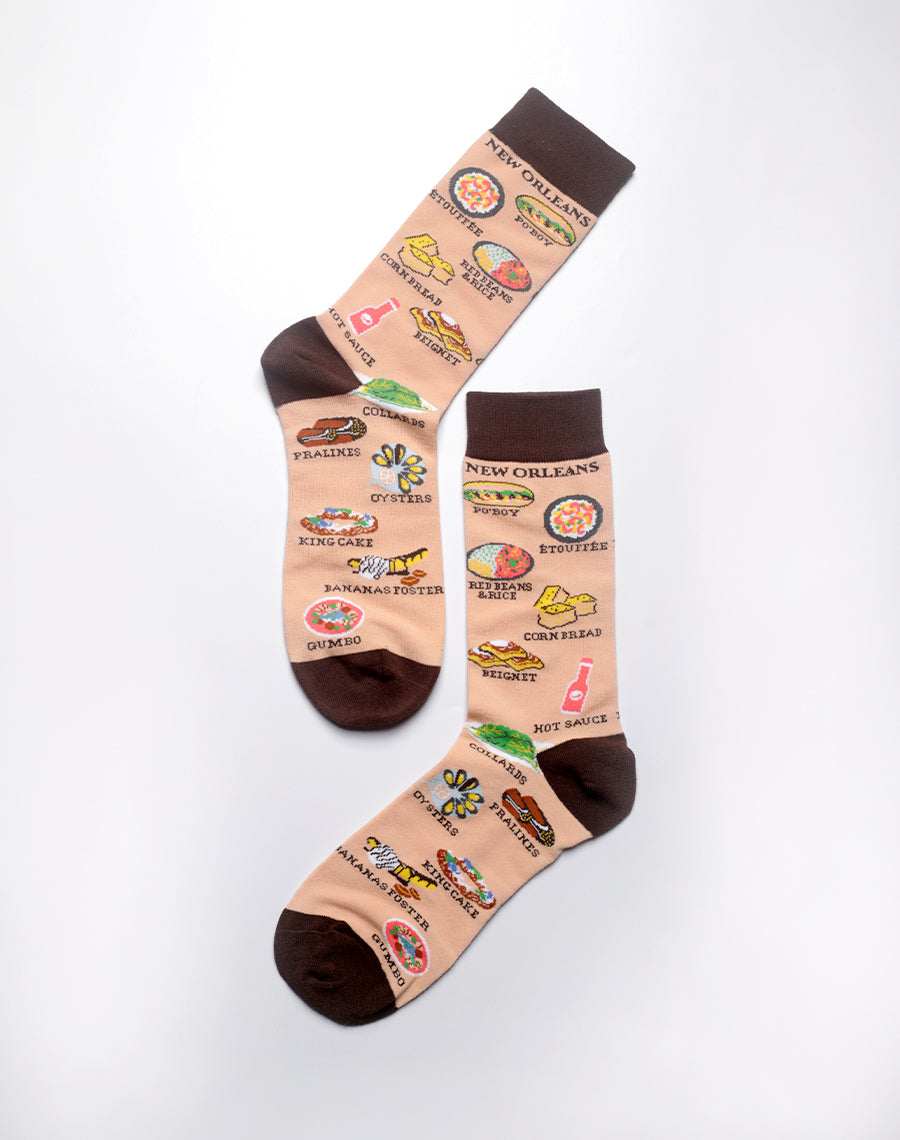 Beige crew socks with New Orleans food illustrations and cultural elements