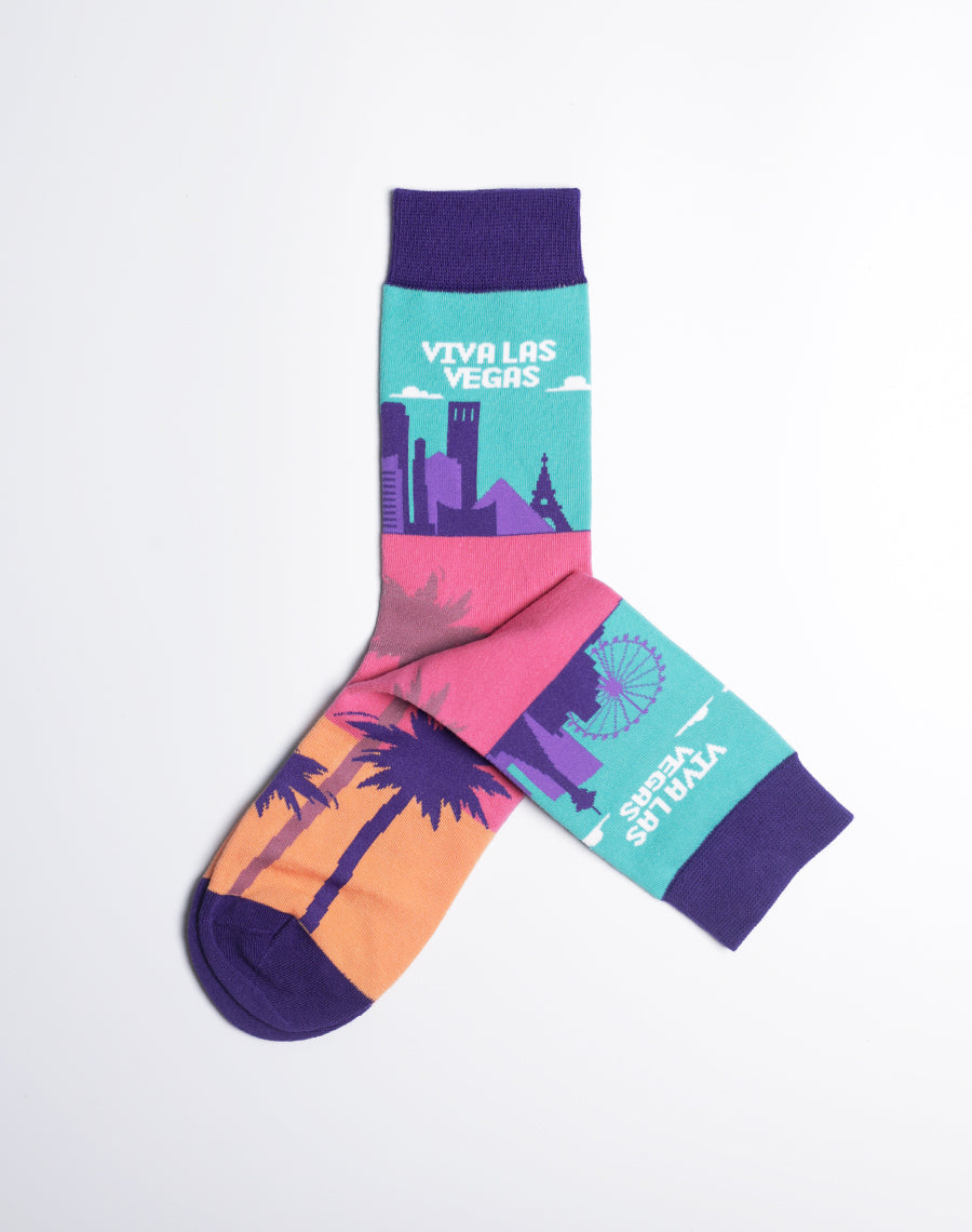 Women's crew socks with a vibrant 'Viva Las Vegas' skyline design, featuring palm trees, colorful buildings, and a Ferris wheel.