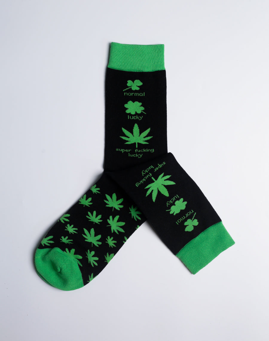 A pair of green and black crew socks featuring a bold weed leaf pattern, perfect for adding a lucky touch to any outfit.