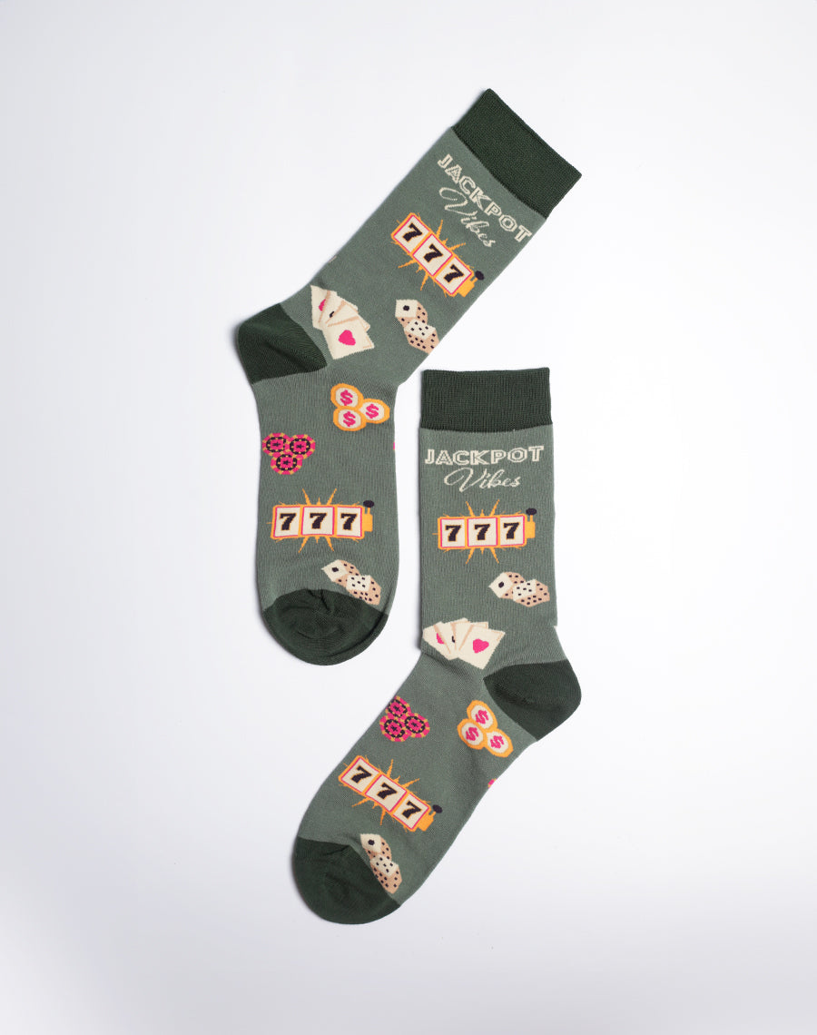 Dark green men's crew socks with a casino vibe, featuring 'Jackpot Vibes', slot machines, and dice details