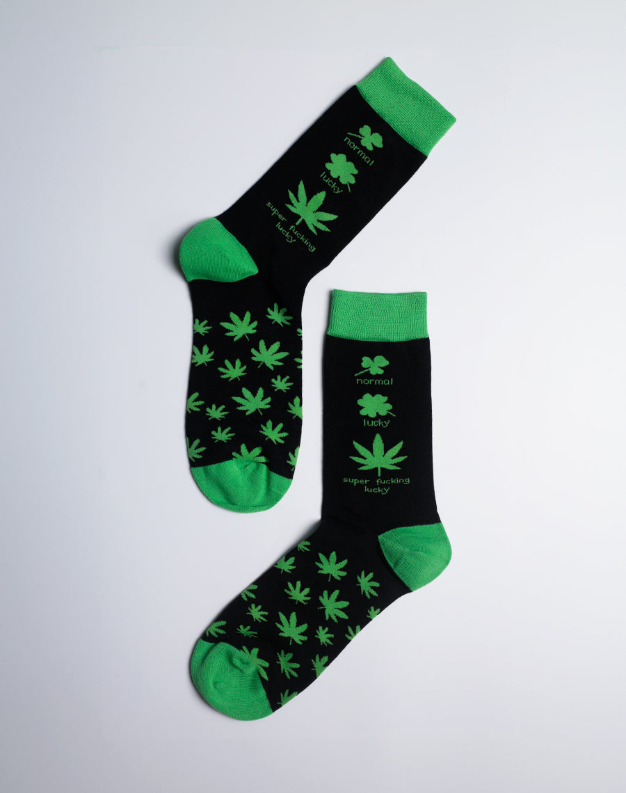 Stylish and comfortable green and black crew socks with an all-over cannabis leaf print, ideal for casual wear.
