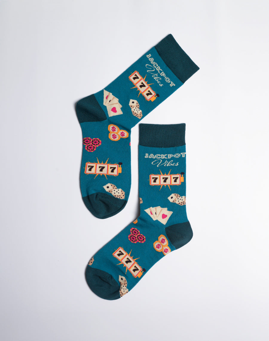 Teal socks with a lively casino theme, featuring slot machines, dice, playing cards, and '777' designs.