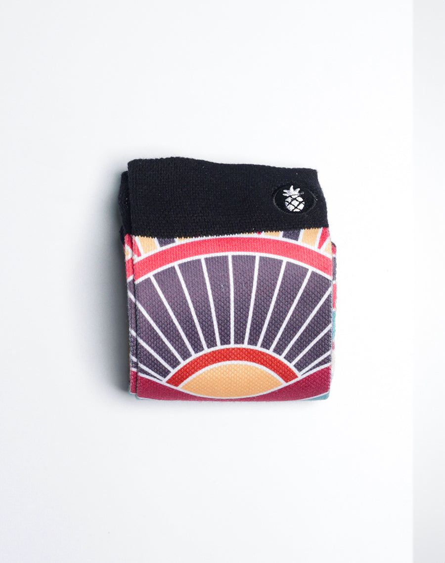 Island-style Hawaiian crew socks with bold tiki mask face pattern in high-resolution print.