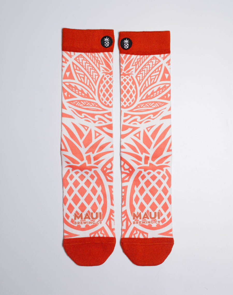 Maui Brewing Co. Pineapple Mana Wheat crew socks with bright orange pineapple tribal print.