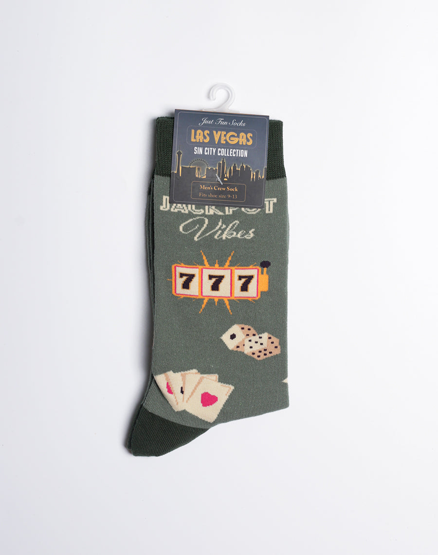 Men's Las Vegas 'Jackpot Vibes' socks with a dark green background, showcasing casino-themed designs like dice and cards.