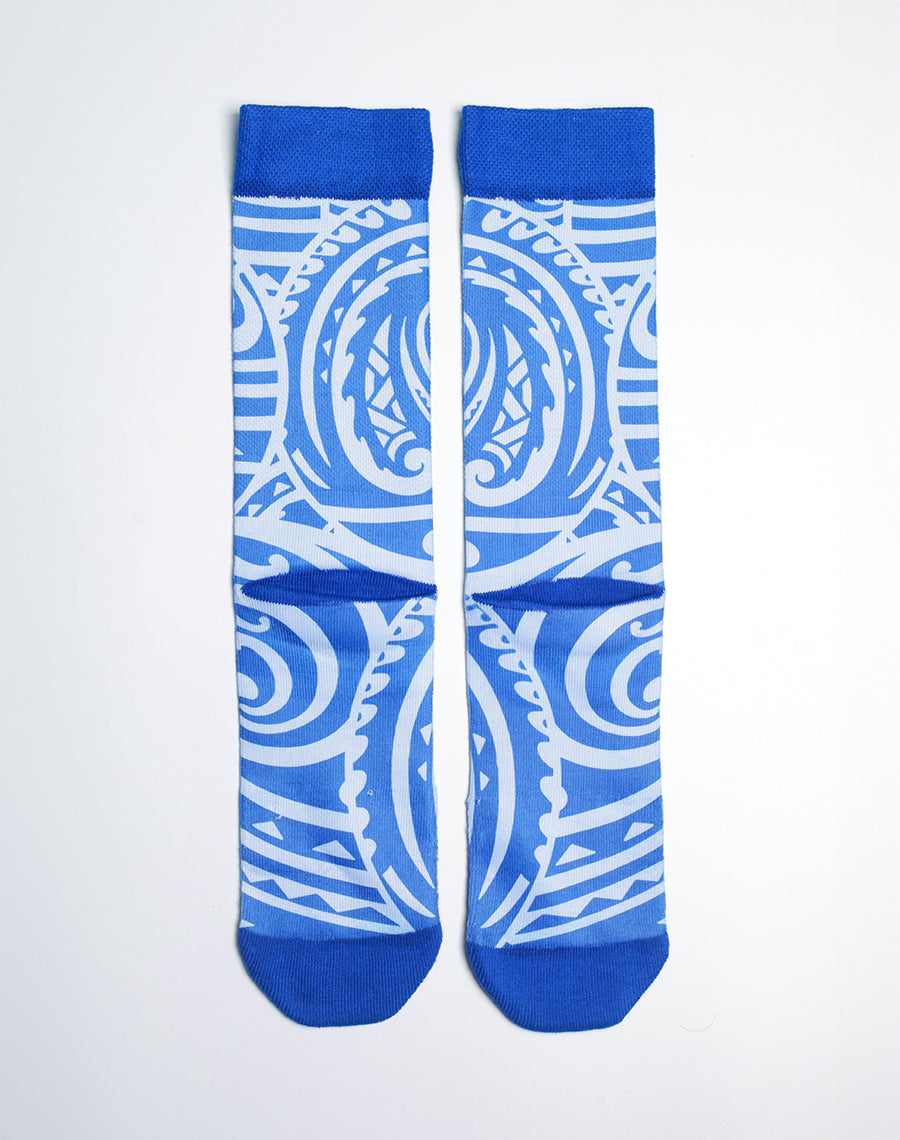Ocean-blue printed crew socks featuring Maui Brewing Co. logo and swirling Hawaiian wave patterns.
