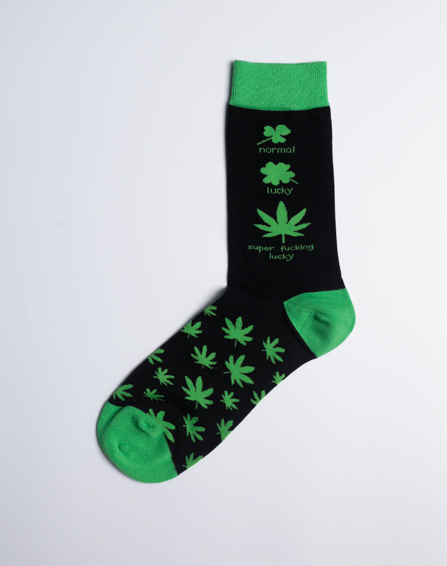 Close-up of the Men's Super Lucky Weed Leaf Crew Socks, showcasing the vibrant green marijuana leaf design on a black background.