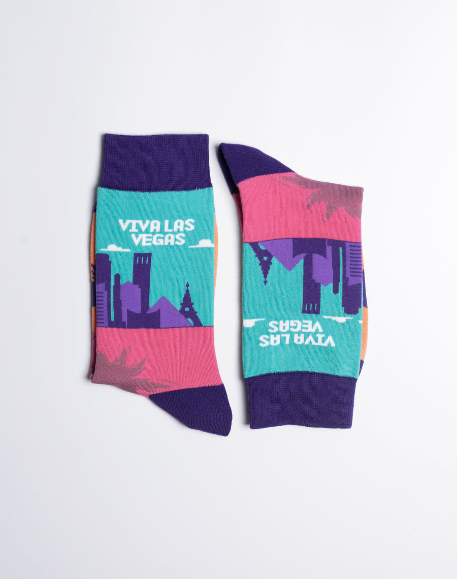 Bright and fun Las Vegas-inspired socks for women, showcasing the city skyline, palm trees, and purple accents.