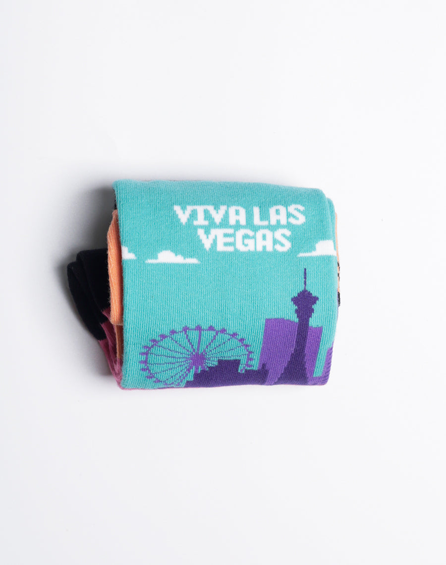 Men’s novelty socks featuring "Viva Las Vegas" text with a mix of city skyline and desert sunset.