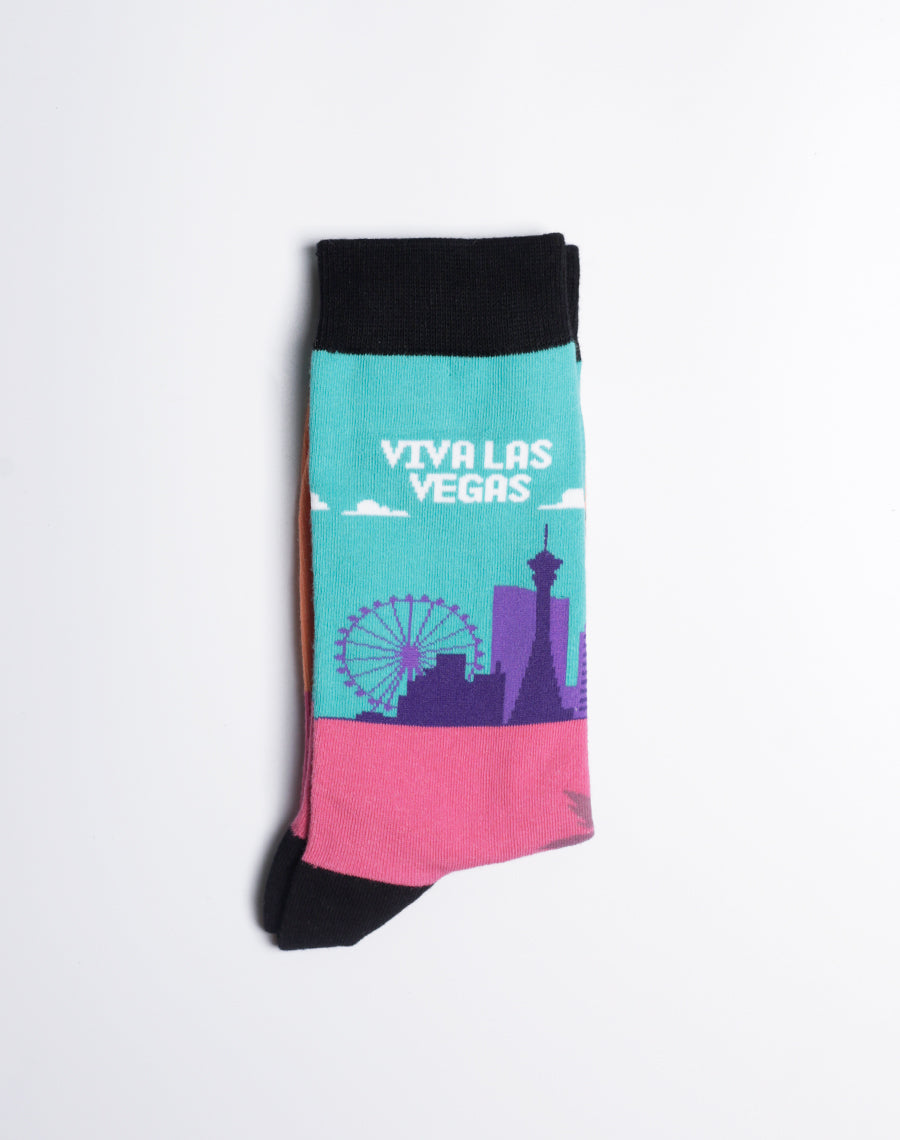 Vegas-inspired crew socks with black cuffs, heels, and toes, highlighting famous landmarks in bold colors.