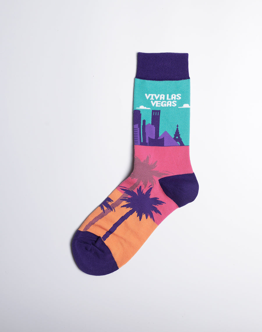 Women's 'Viva Las Vegas' socks in turquoise, pink, and purple, highlighting iconic skyline elements and desert vibes.