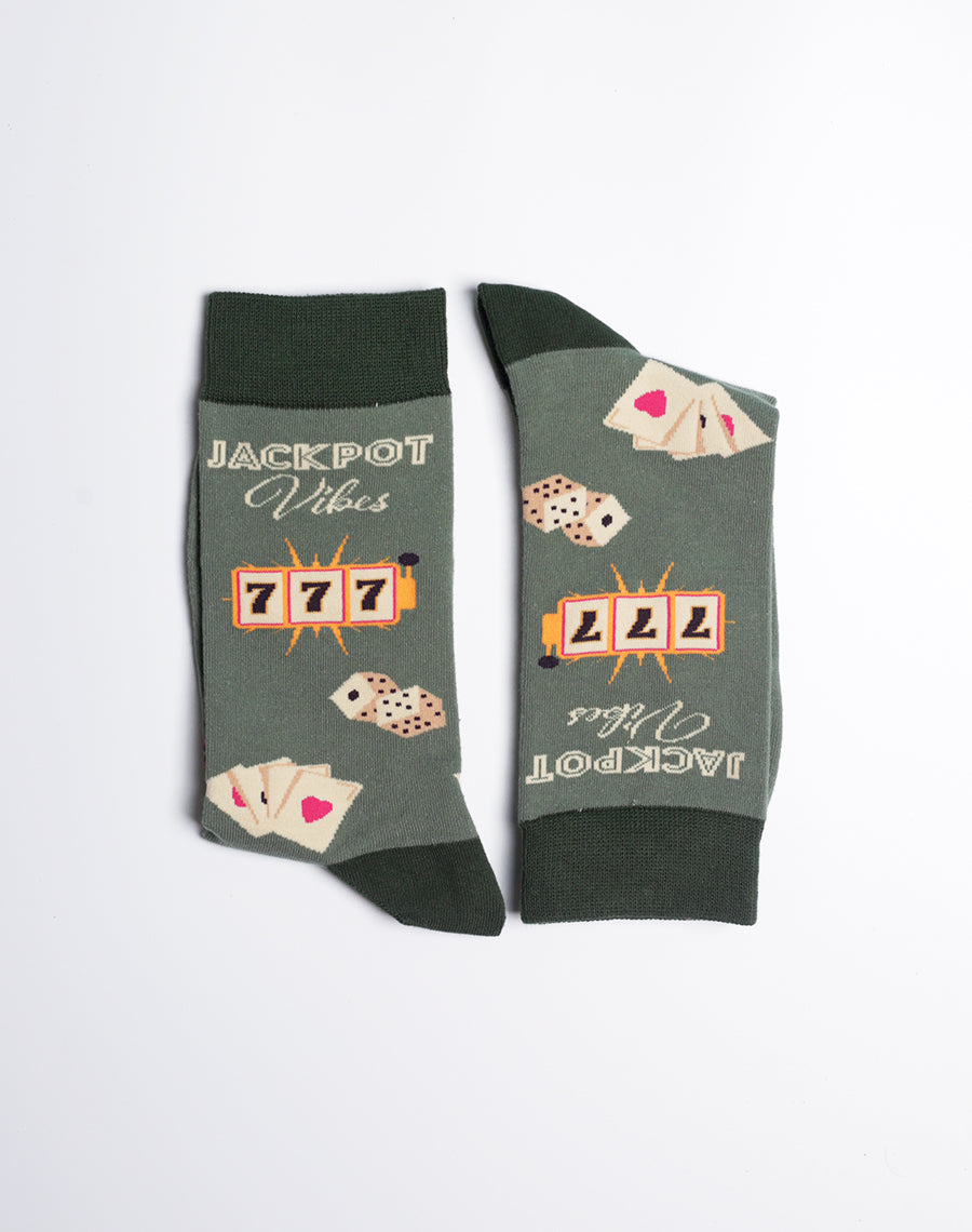 Stylish dark green casino-themed socks for men, decorated with slot machine graphics, dice, and the text '777'.